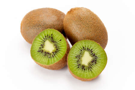 Two whole and one sliced kiwi fruit against a white background.の写真素材