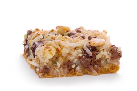 Seven layer bar made with a graham cracker crust topped with chocolate chips, coconut, and chopped nuts.の写真素材