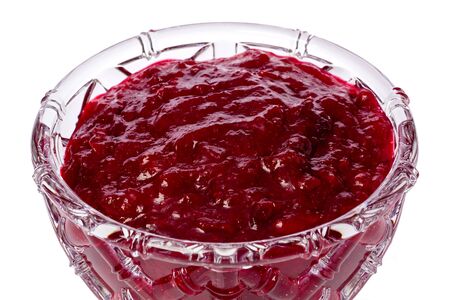 Closeup of a bowl cranberry sauce against a white background.の写真素材
