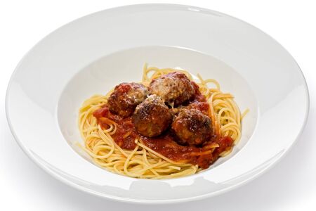 Spaghetti and meatballs in a white bowl against a white background.の写真素材