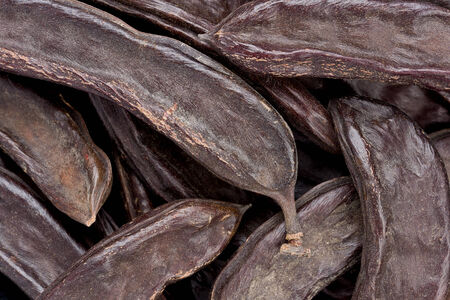 Background texture of several whole carob pods, also known as St. John's-bread.の写真素材
