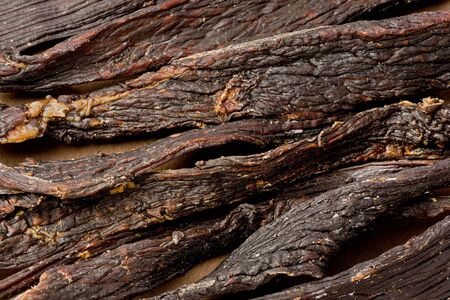 Background texture of several pieces of black pepper beef jerky.の写真素材