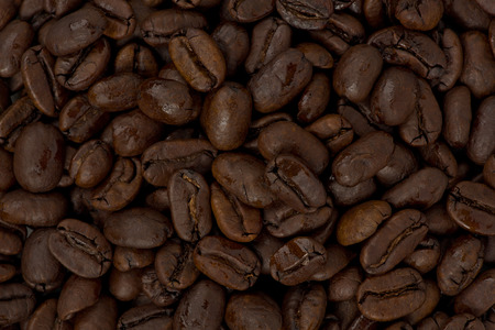 Background texture of whole dark roasted coffee beans.の写真素材