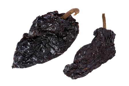 Two, whole, dried, Poblano chile peppers against a white background.の写真素材