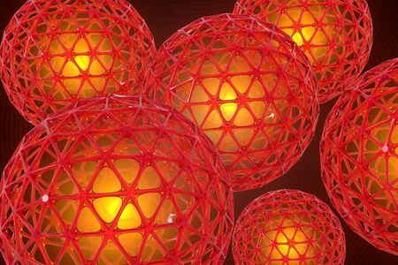 3D render of several red lattice spheres against a dark background. Each sphere has a golden glow in the center.の写真素材