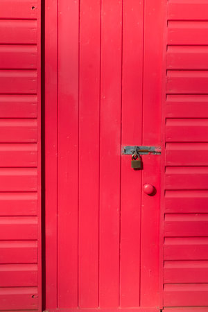 A close-up of a bright red beach hut in Llanbedrog North Walesの写真素材