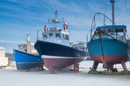 Fishing boats out of water. Wick Harbour. Three fishing boats out of the water on the dockside. The...