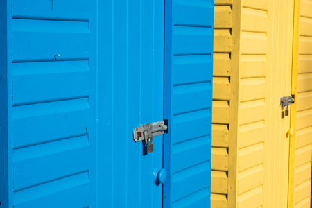 A close-up of yellow and blue beach huts in Llanbedrog North Walesの写真素材