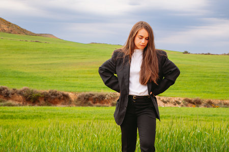 Beautiful woman resting relaxing on a green fields walk in natureの写真素材