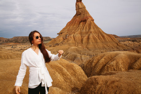 Beautiful woman traveling in a deserted landscape of the Bardenas Realesの写真素材