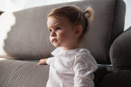 Detail of a portrait of a baby girl attentive to the tv