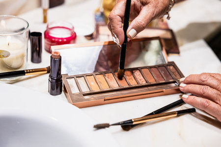 Detail of woman's hand with palette of makeup shadesの写真素材
