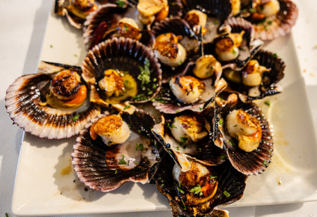 Detail of a plate of very tasty cooked scallops ready to eat.