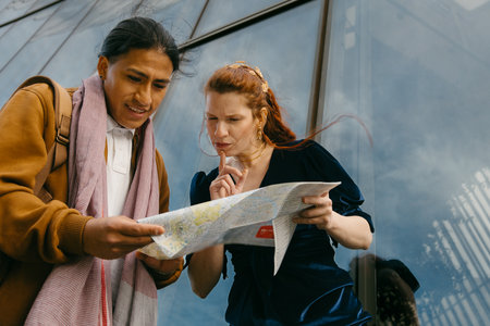 A man and woman pause to contemplate their next move on a city map during their urban excursion.