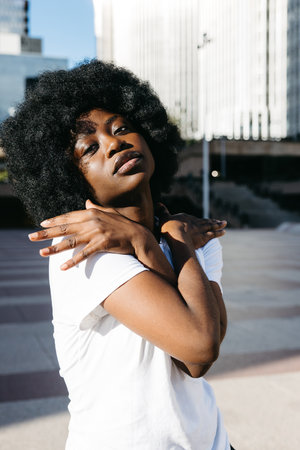 Confident Afro woman looking at camera with expressive pose