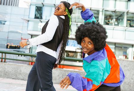 Energetic Afro girls dancing and having fun in city streetの写真素材