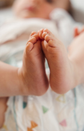 Chubby baby feet in focus, showing warmth and innocenceの写真素材