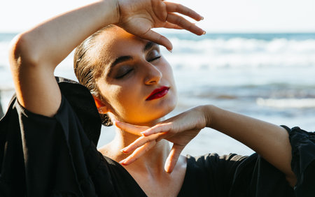 Relaxed flamenco dancer with eyes closed at the beachの写真素材