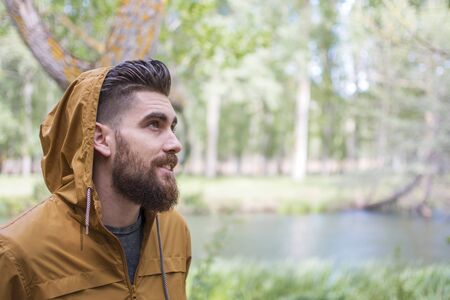 Smiling man enjoying the autumnal nature.の写真素材