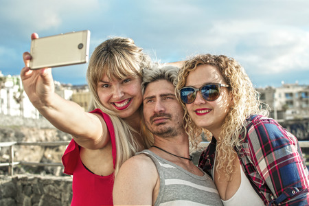 Happy young people taking a selfieの写真素材