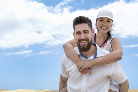 Young couple enjoying a piggy back rideの写真素材