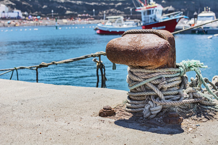 Mooring rope in the harbor, with the sea and yachts in the background.の写真素材