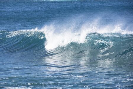 A wave breaking in the blue Atlantic ocean