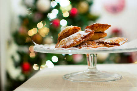 Christmas dumplings with icing sugar on top on a glass tray.の写真素材