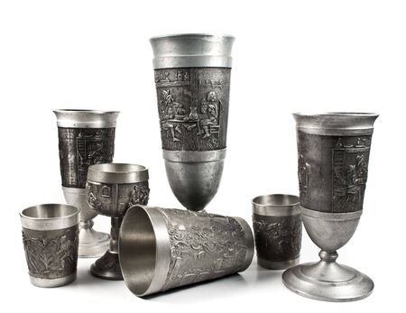 Seven silver cups with medieval sculpture isolated on a white backgroundの写真素材