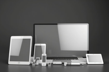 A picture featuring three laptops and a monitor placed on a table. Suitable for technology-related articles or websitesの素材