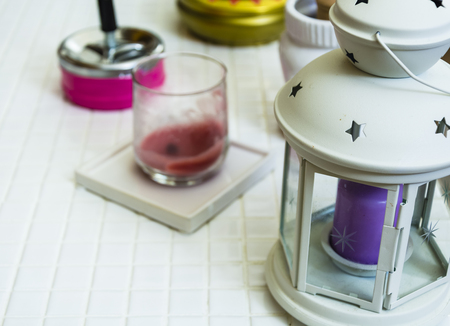 Softly purple candle in the ITS white lantern