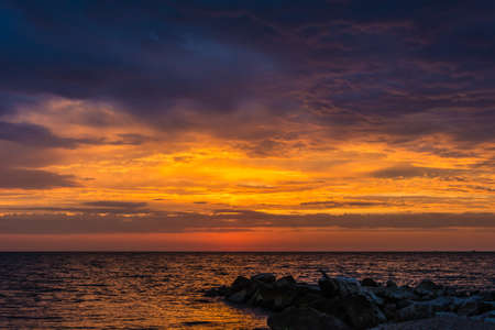 late summer dawn with a cloudy and warm skyの写真素材