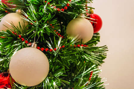 Close up of a decorated christmas tree with white and red ballsの写真素材