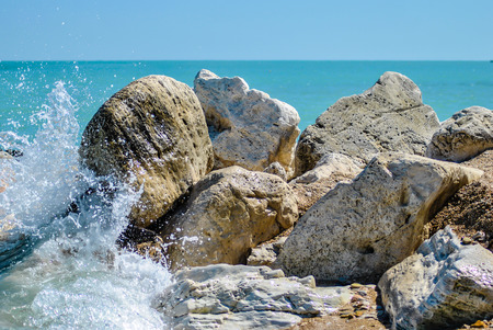 wave crashing on a cliff with foamの写真素材