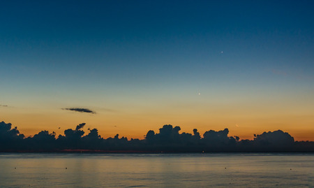 dawn at sea with clouds in a summer morningの写真素材