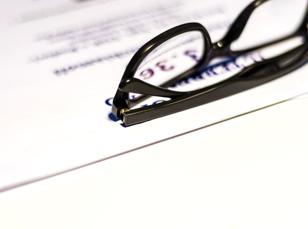 Glasses on sheets with printed numbersの写真素材