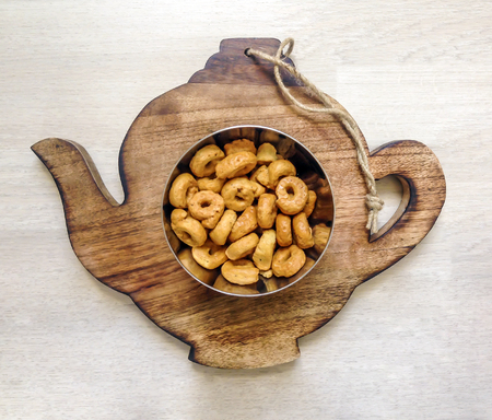 top shot of italian taralli in a silver plate over a wooden plainの写真素材
