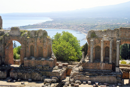 the Ancient Theatre of Taormina with Etna Mountain and mediterranean sea in background in Sicily, Italyの写真素材