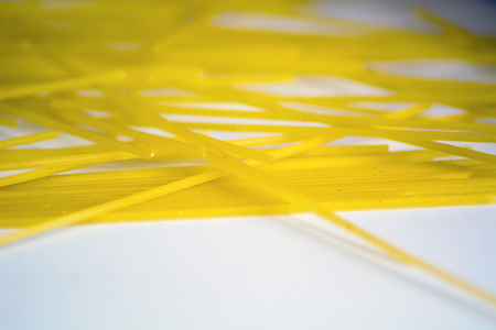raw spaghetti pasta on a white background. Macro shotの写真素材