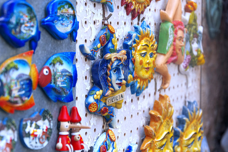 Souvenirs of the Trinacria symbol of Sicily and typical Sicilian glazed ceramicの写真素材