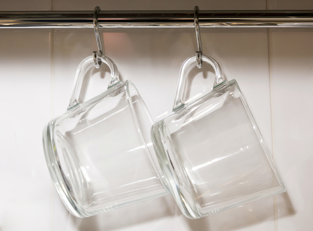 two glass transparent hanging mugsの写真素材