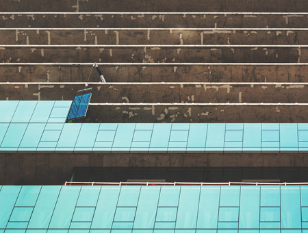 a crane placing a glass in a construction site of a modern skyscraper