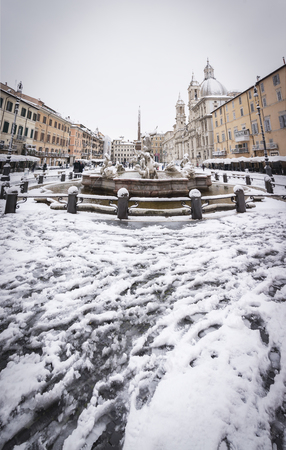 Rome, Italy, february 26th, 2018: Piazza Navona in Rome covered with snow with citizens and tourists walking in wonder after the unusual snowfall of February 26th 2018のeditorial素材