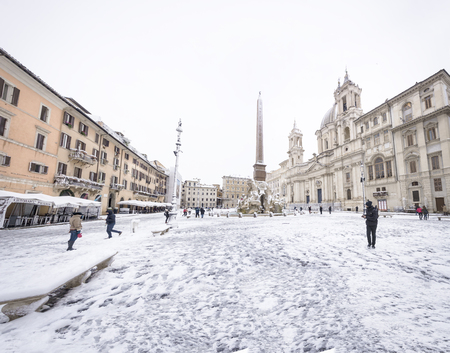Rome, Italy, february 26th, 2018: Piazza Navona in Rome covered with snow with citizens and tourists walking in wonder after the unusual snowfall of February 26th 2018のeditorial素材