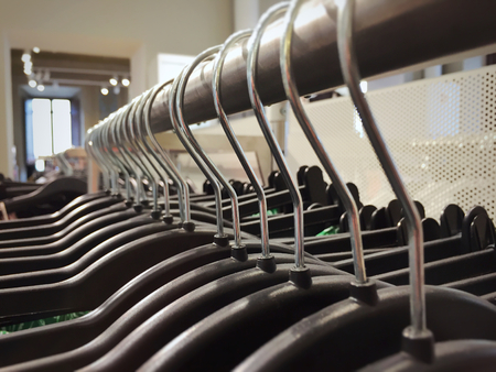 Many hangers on a clothes rack in a fashion storeの写真素材