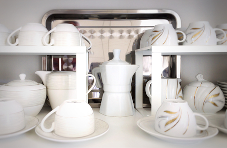 Cups on the white shelves in the storeの写真素材