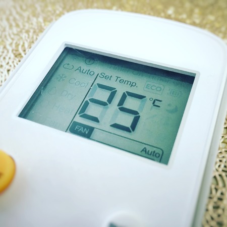 Display of an air conditioner remote control with the temperature set at 25 degreesの写真素材