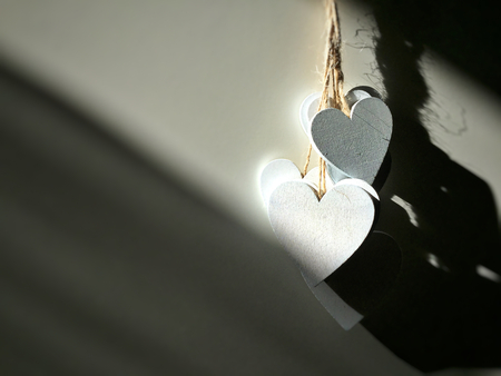 White wooden hearts hanging. Love and romance conceptの写真素材