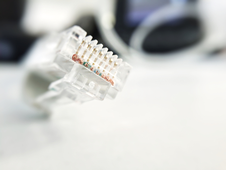 Internet ethernet cable, connector close up on an blurred background