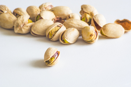 Close Up Group Of Dry, Fresh And Large Raw Pistachio Nuts In Shell Isolated On White Background, Selective Focusの写真素材